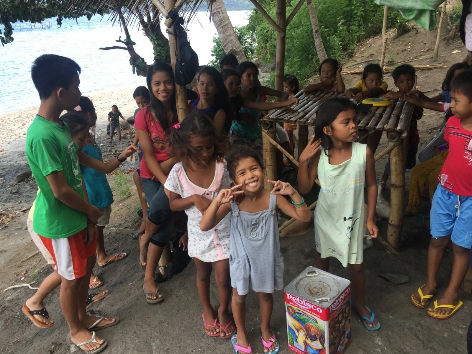 Children receiving community support in Philippine coastal village